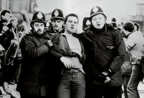 A protester is led away by police officers during clashes with miners in Sheffield in 1984