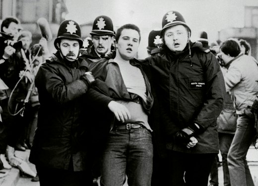 A protester is led away by police officers during clashes with miners in Sheffield in 1984