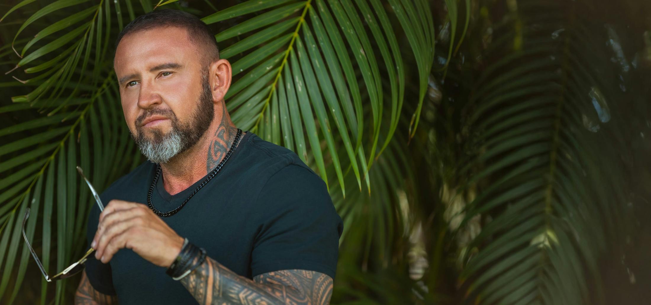 man standing in front of trees