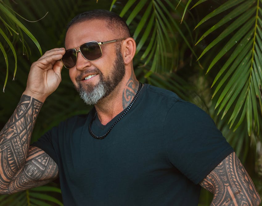 Man touching his sunglasses