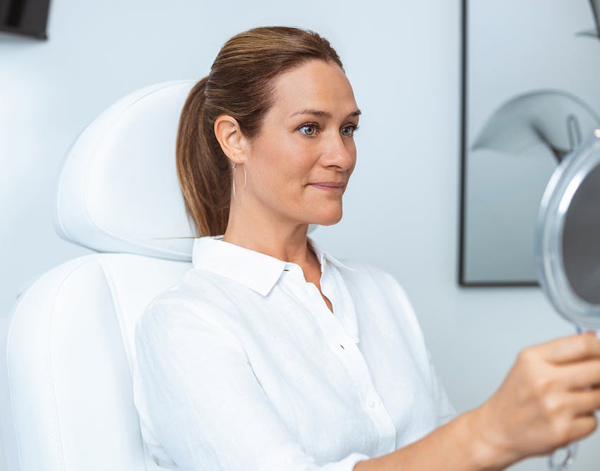 Woman looking at herself in mirror