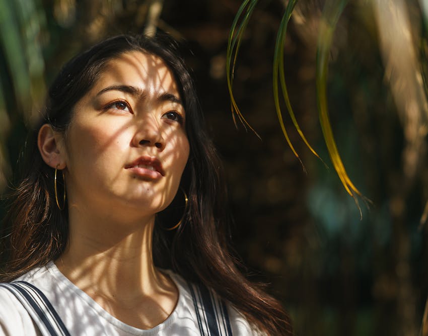 Woman staring straight ahead with shadows on her face