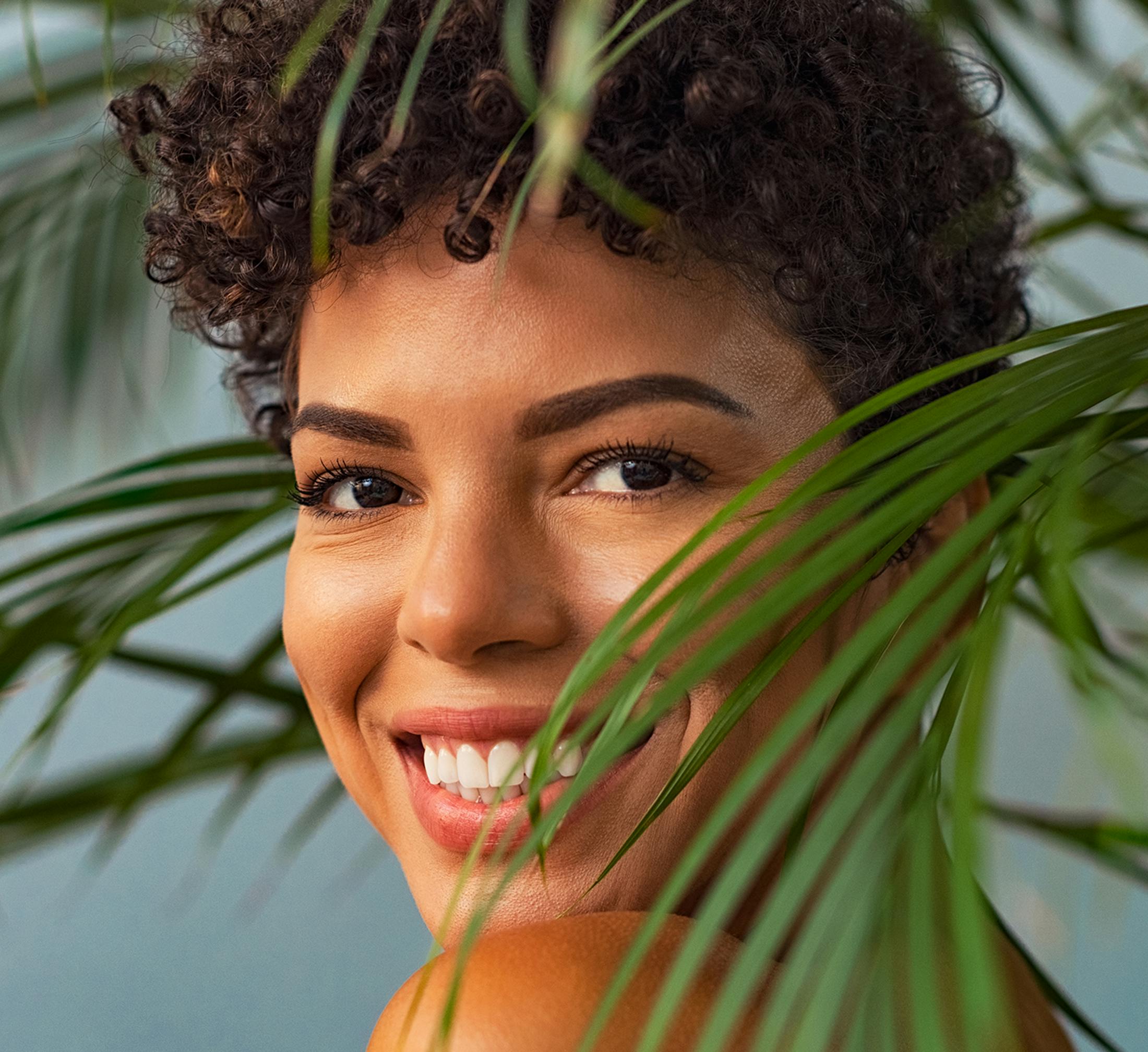 Woman smiling with leaves around her