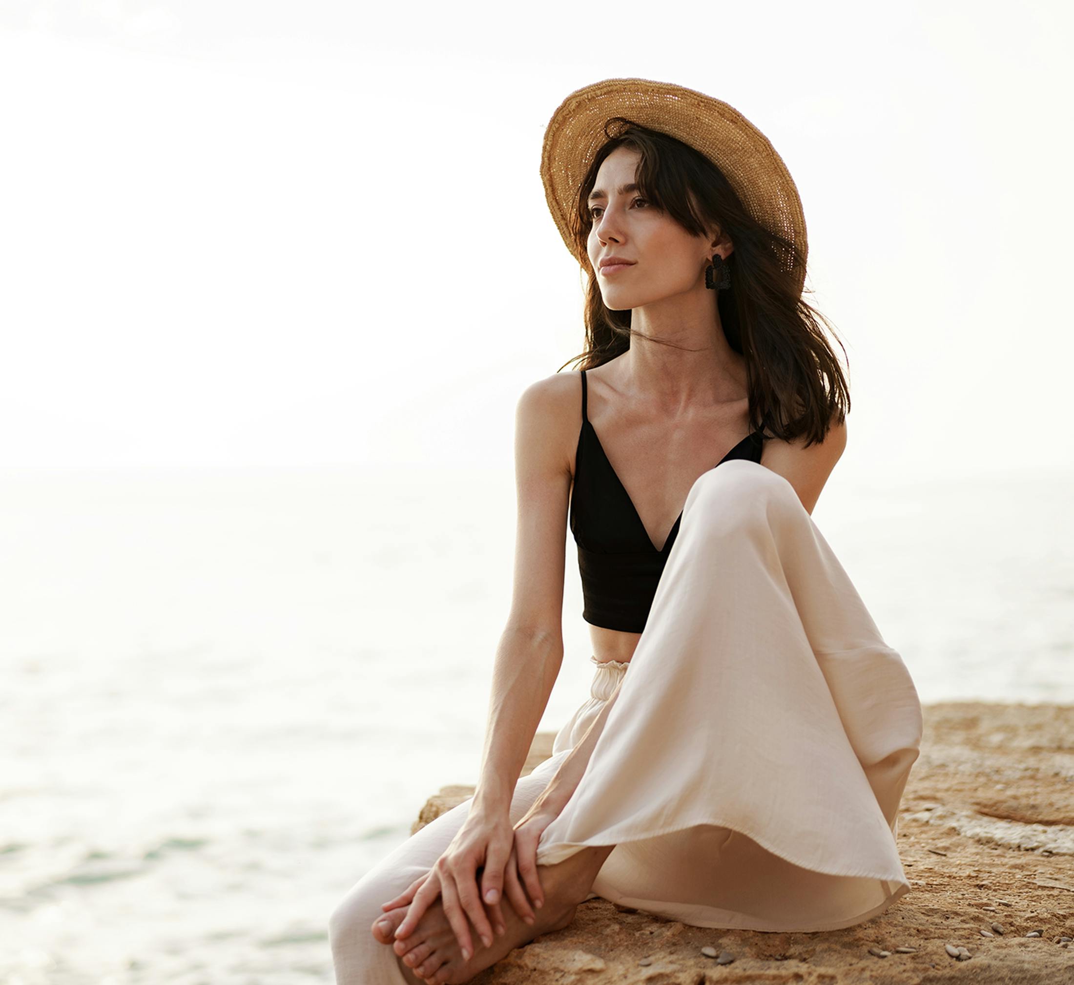 Woman sitting with her leg bent