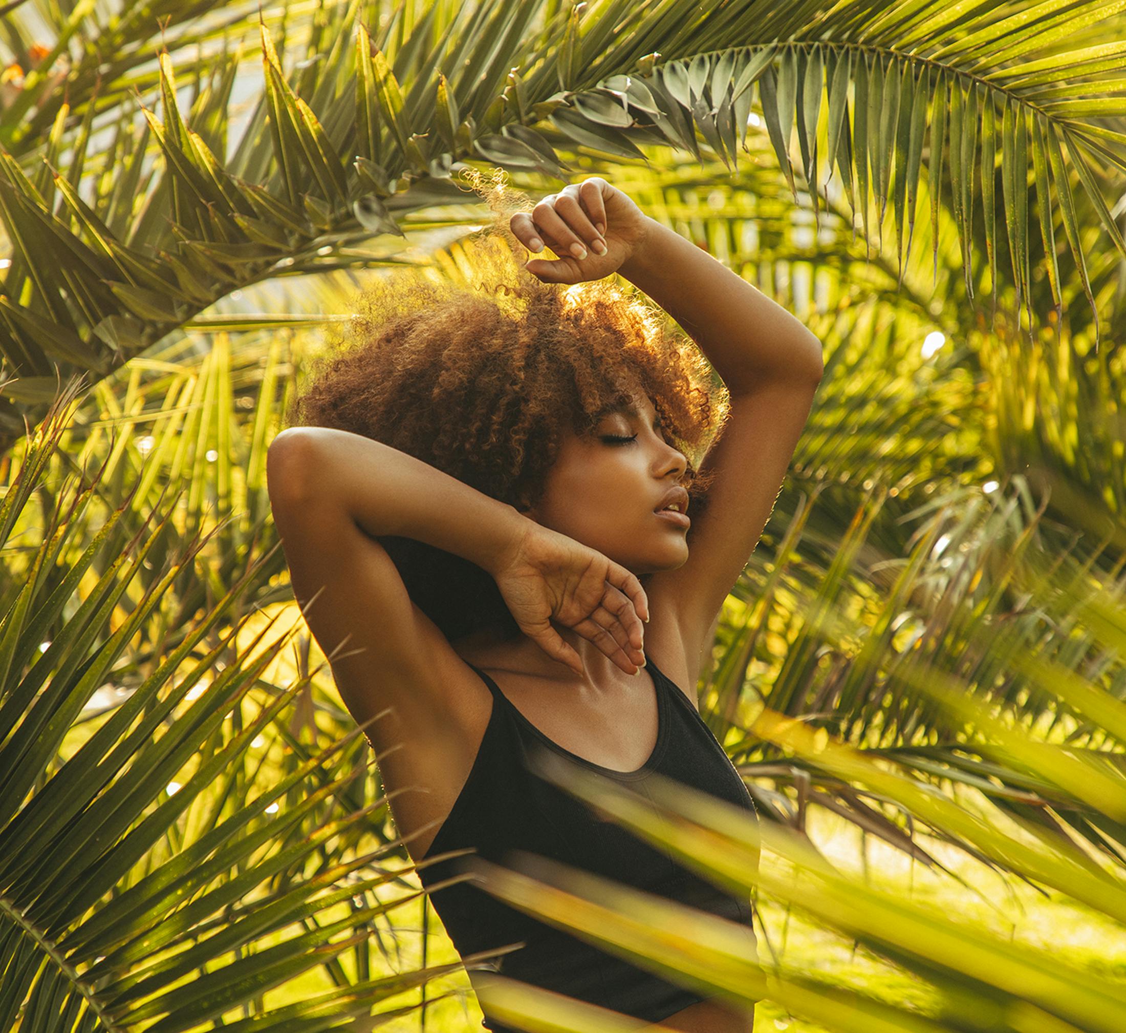 Woman posing with her hand above her head