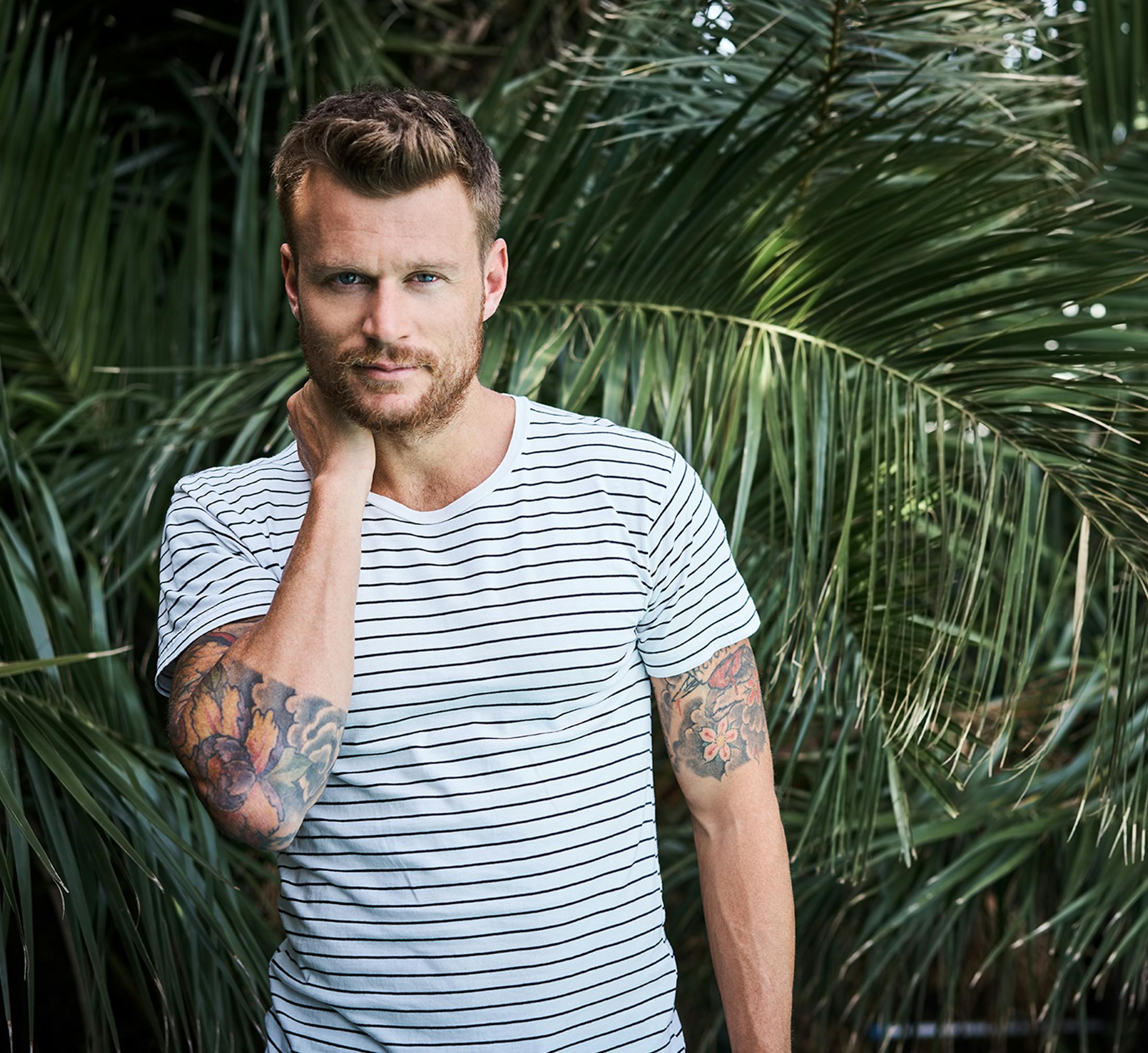 man with his hand on his neck