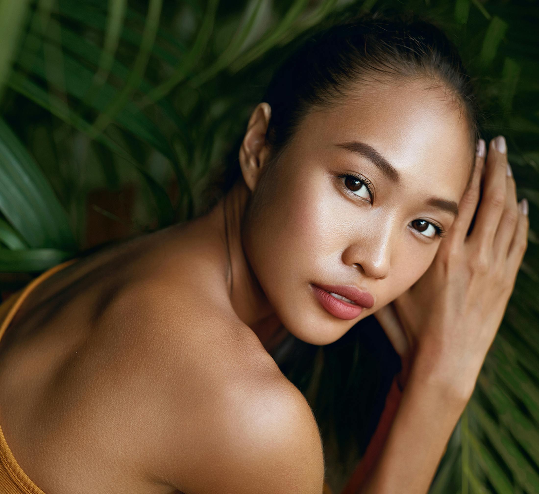 Woman posing with her hands under her head