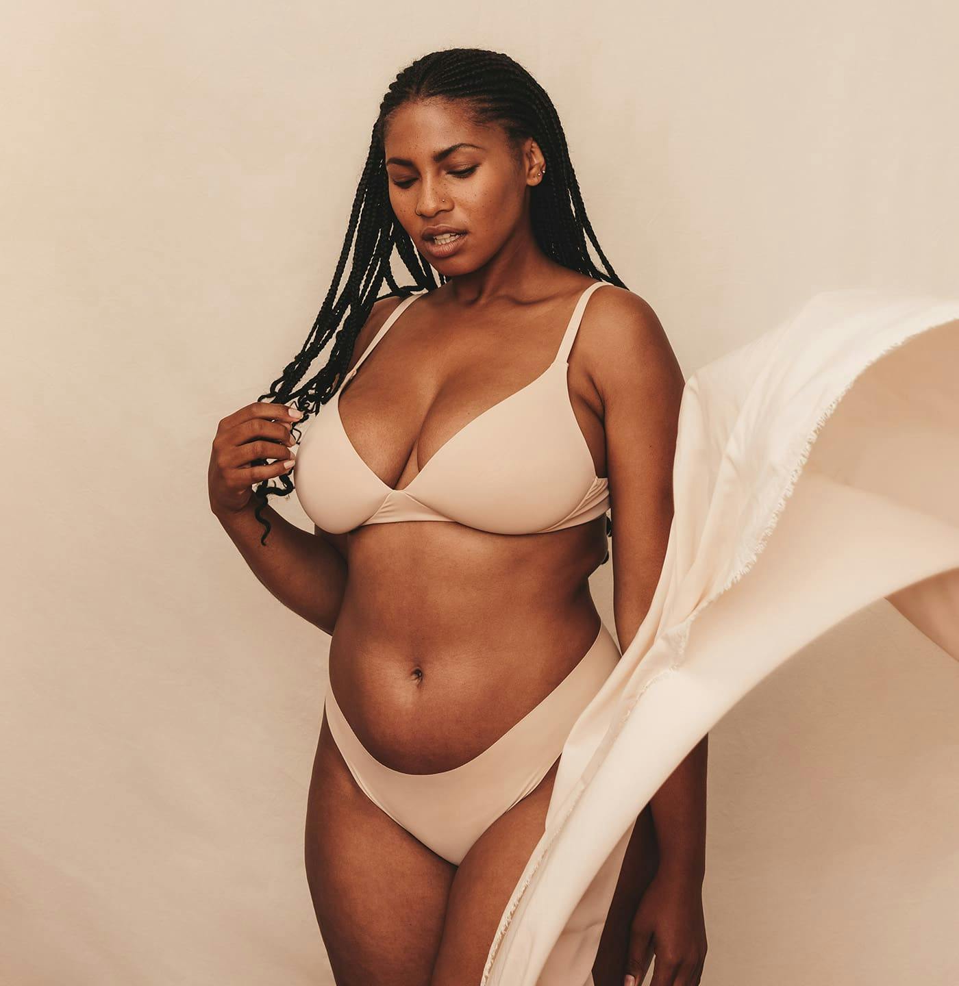 woman standing in beige underwear set