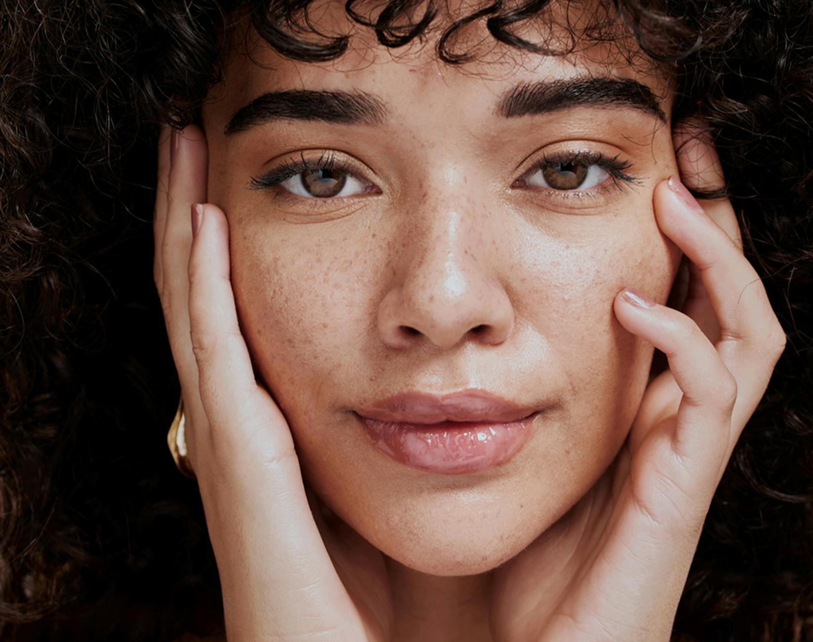 woman touching her own face