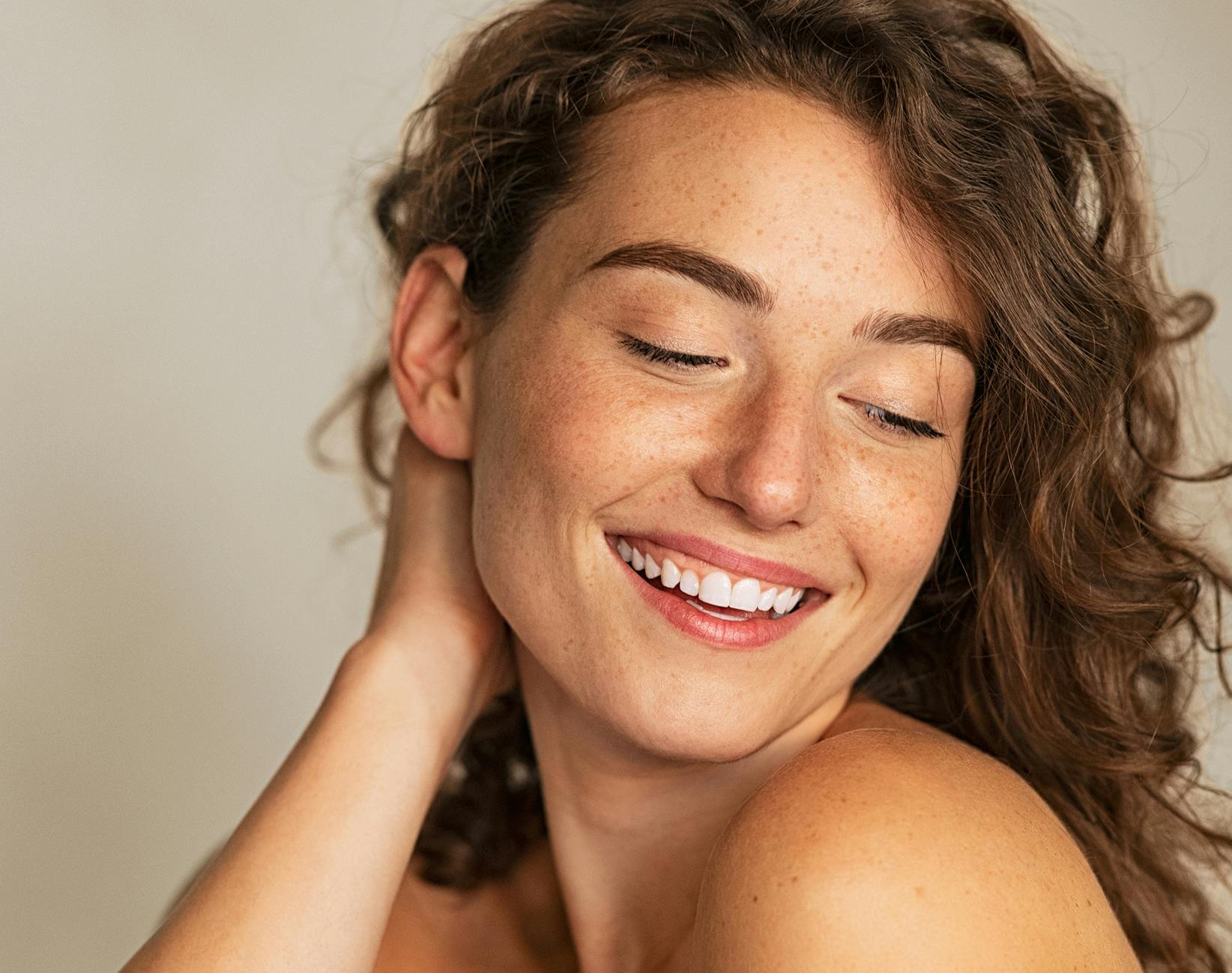 woman touching the back of her neck