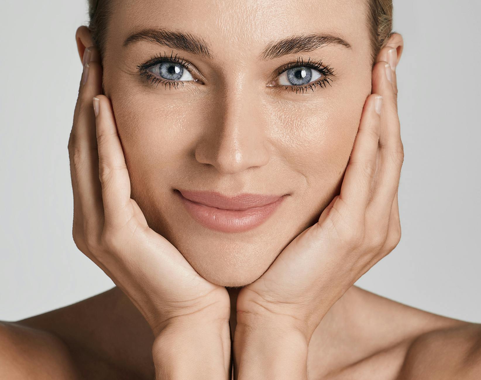 woman cupping her face in her hands