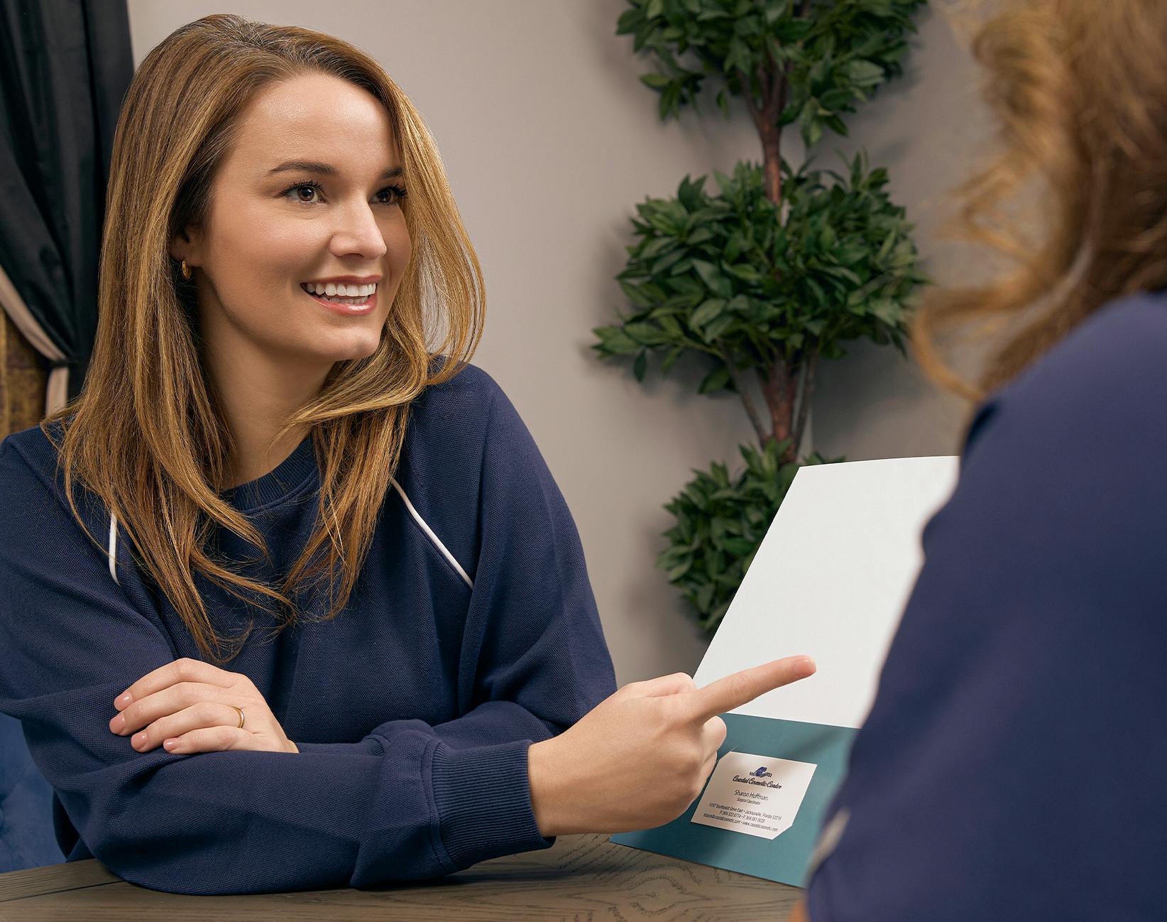 woman pointing at paper