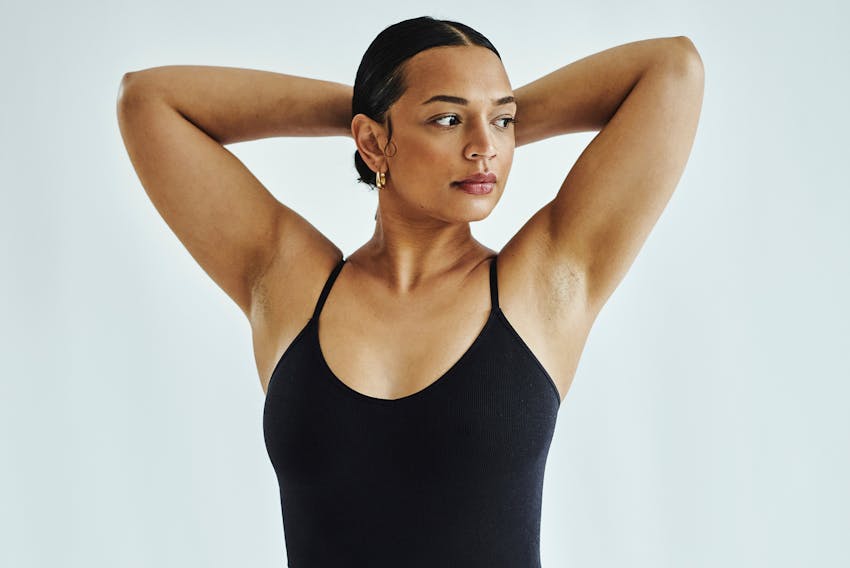 woman with arms on head