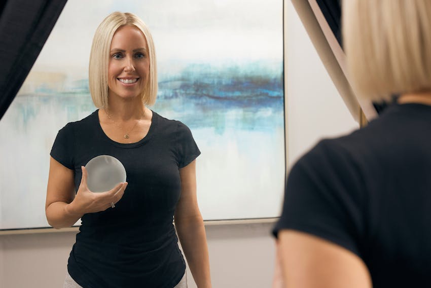 woman holding breast impant