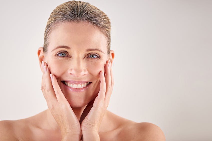 woman touching her face