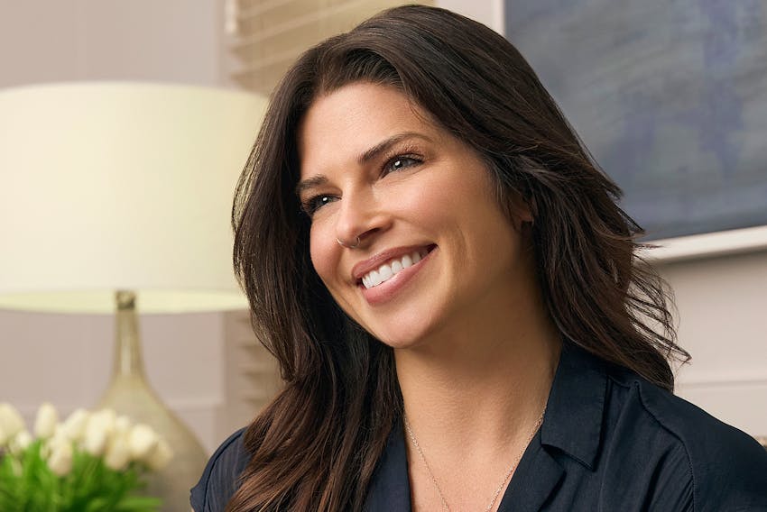 woman smiling with head tilted to the side