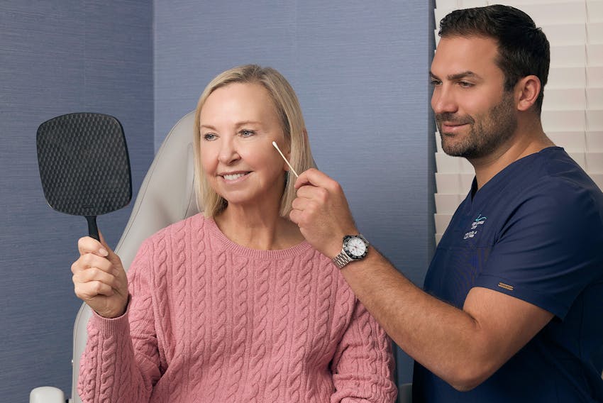 doctor pointing to a woman's face with a q-tip