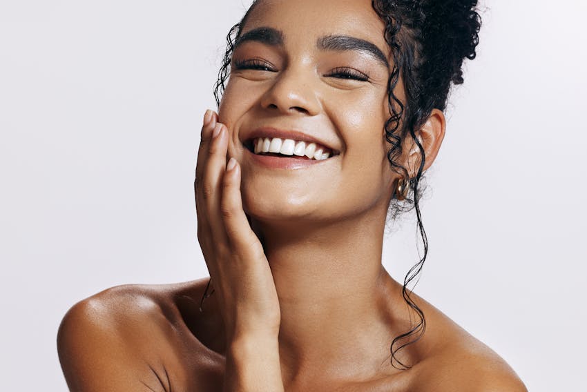 woman touching her cheek