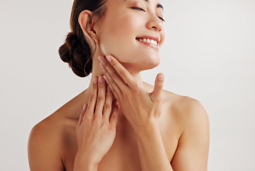 woman touching her neck