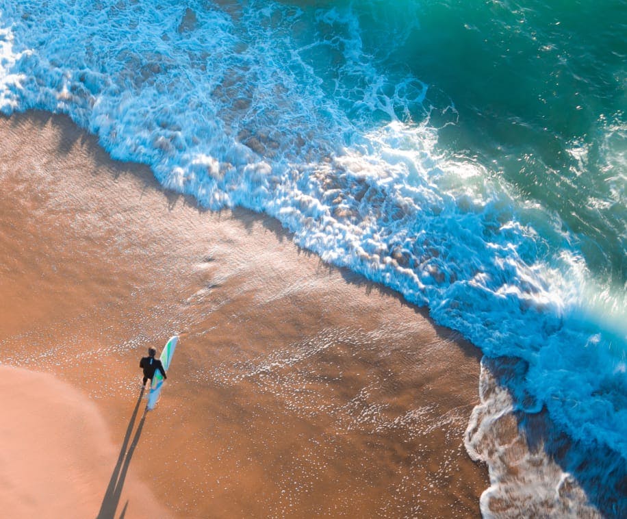 surfer standing on a beach