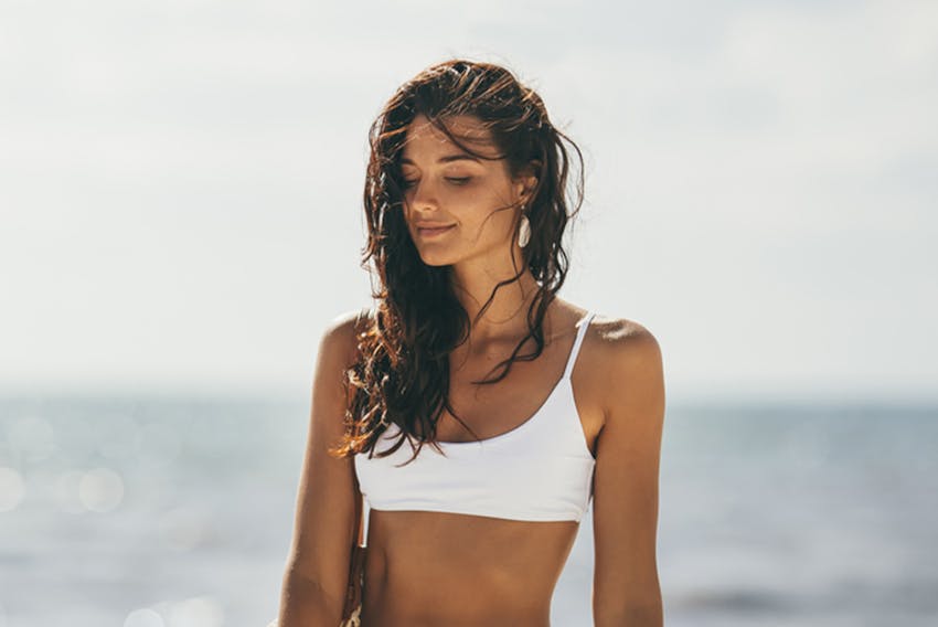 woman turned to the side touching hair