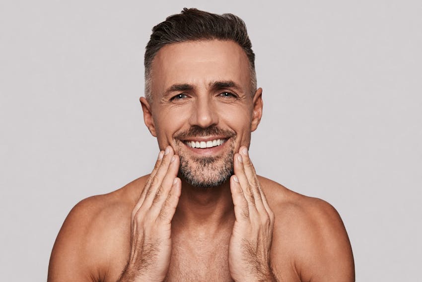 man touching his face