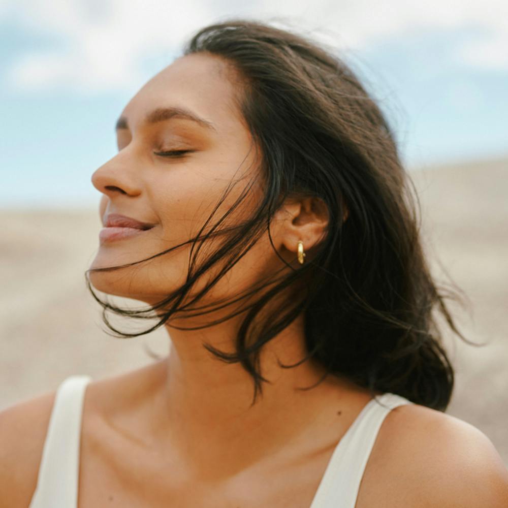 woman smiling with her eyes closed