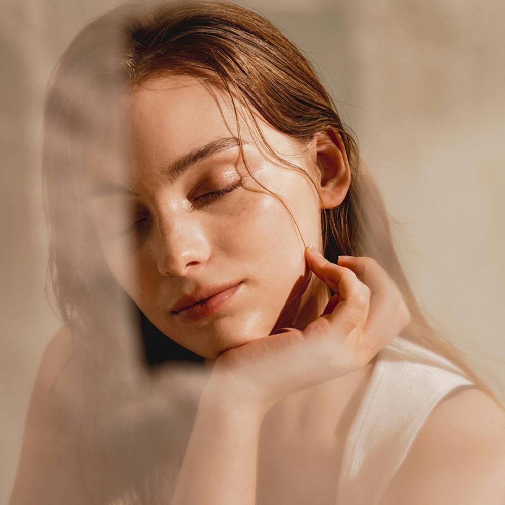 woman resting her face on her hand