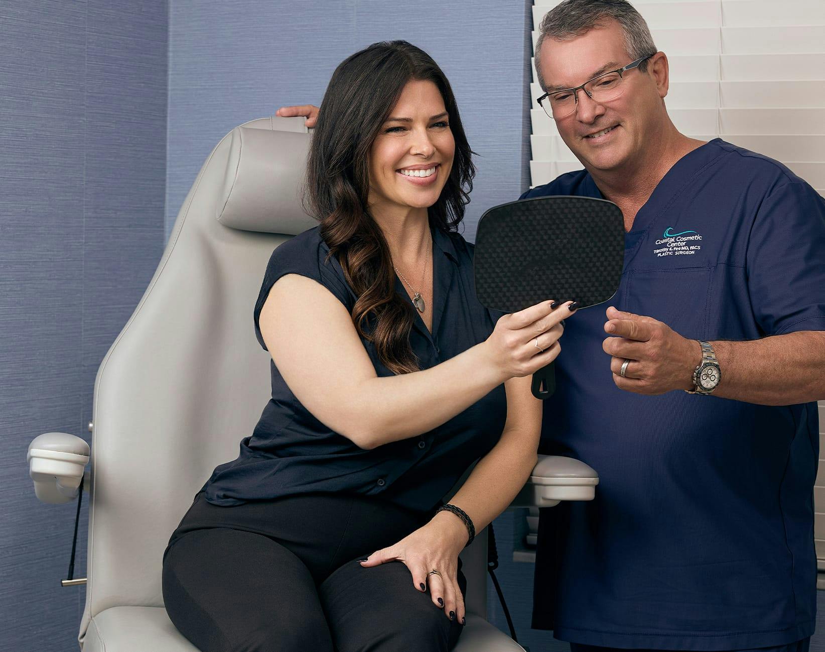 doctor showing a patient her face in a hand mirror