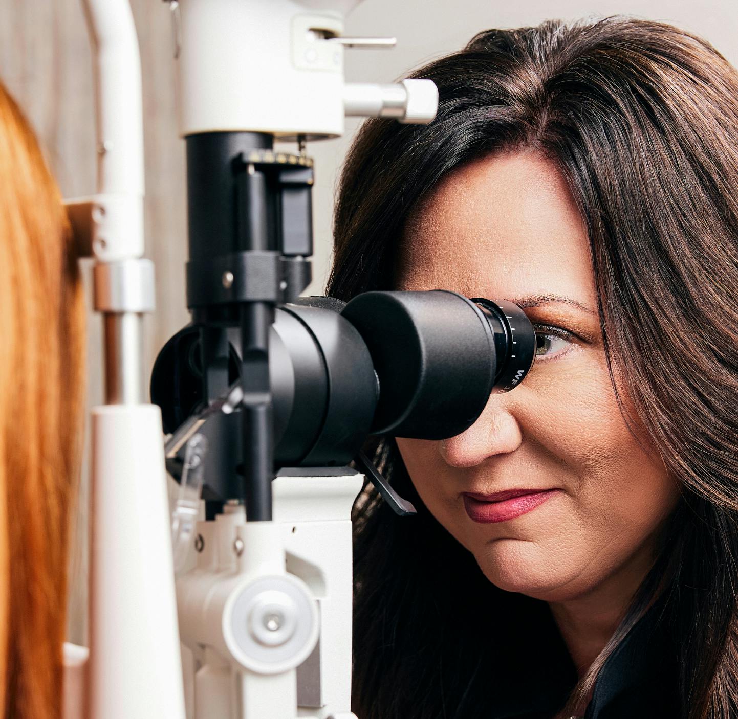 doctor checking a patient's eyes