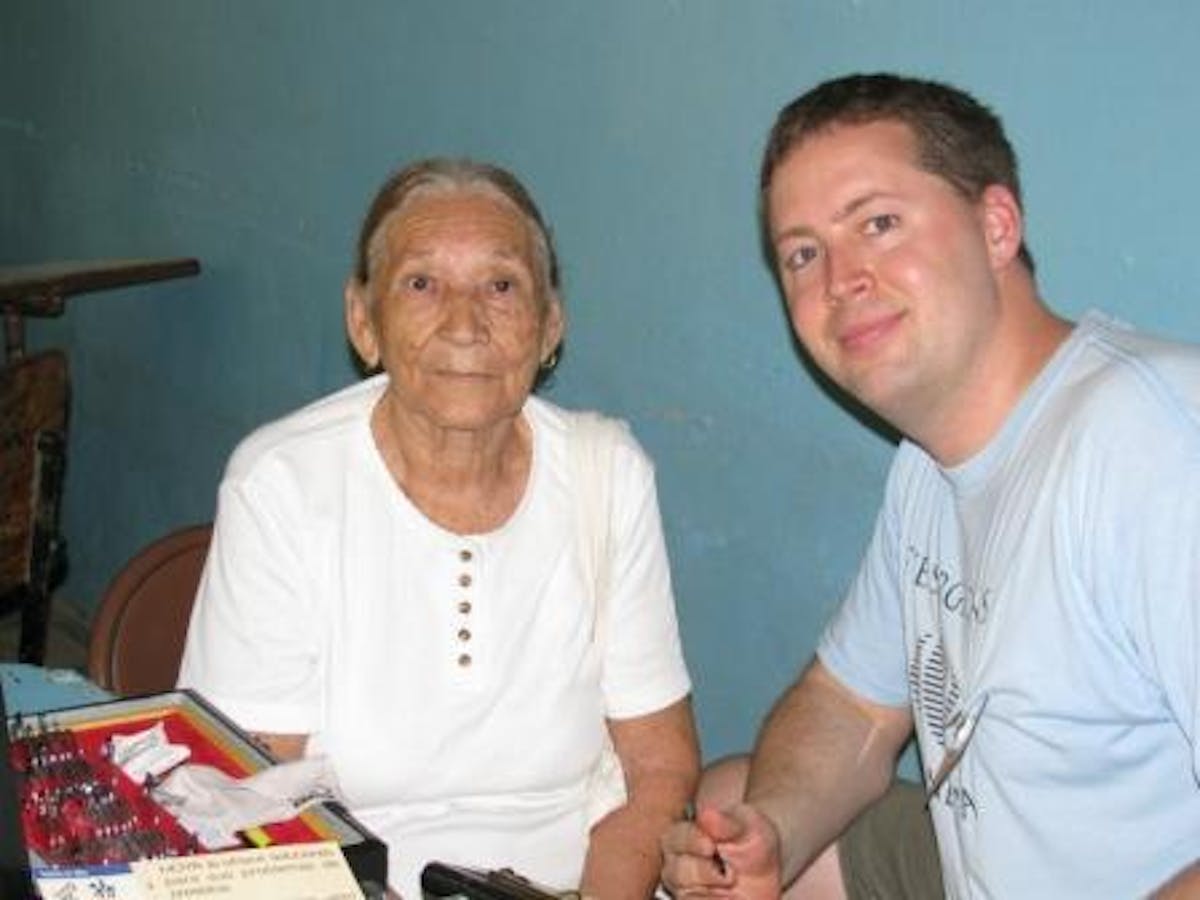 Man sitting with grandmother at a table