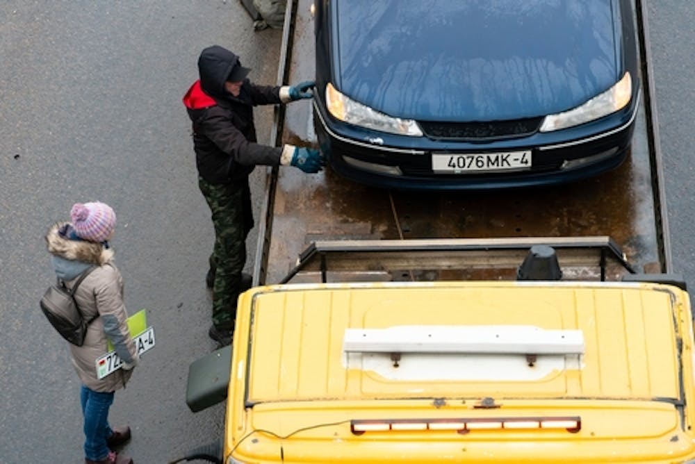 car being loaded onto a tow truck