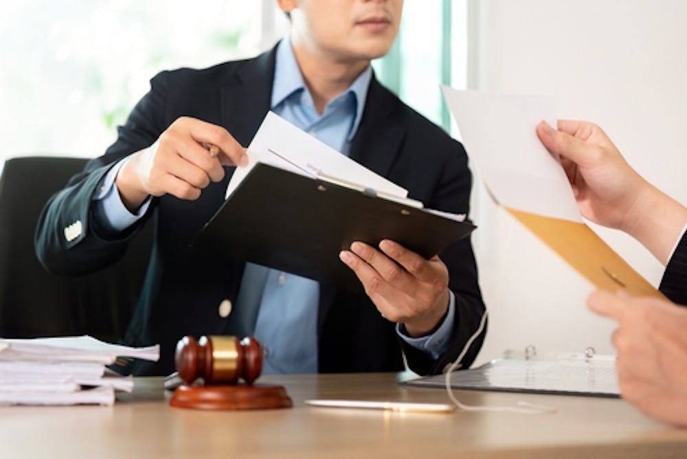 premise liability in South Carolina Lawyer handing a paper to a client