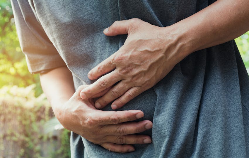 person clutching their stomach in pain