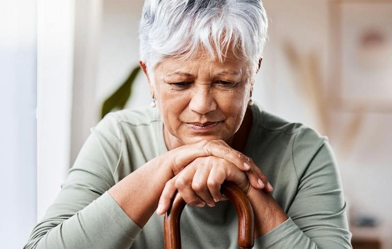 holder woman leaning on a cane