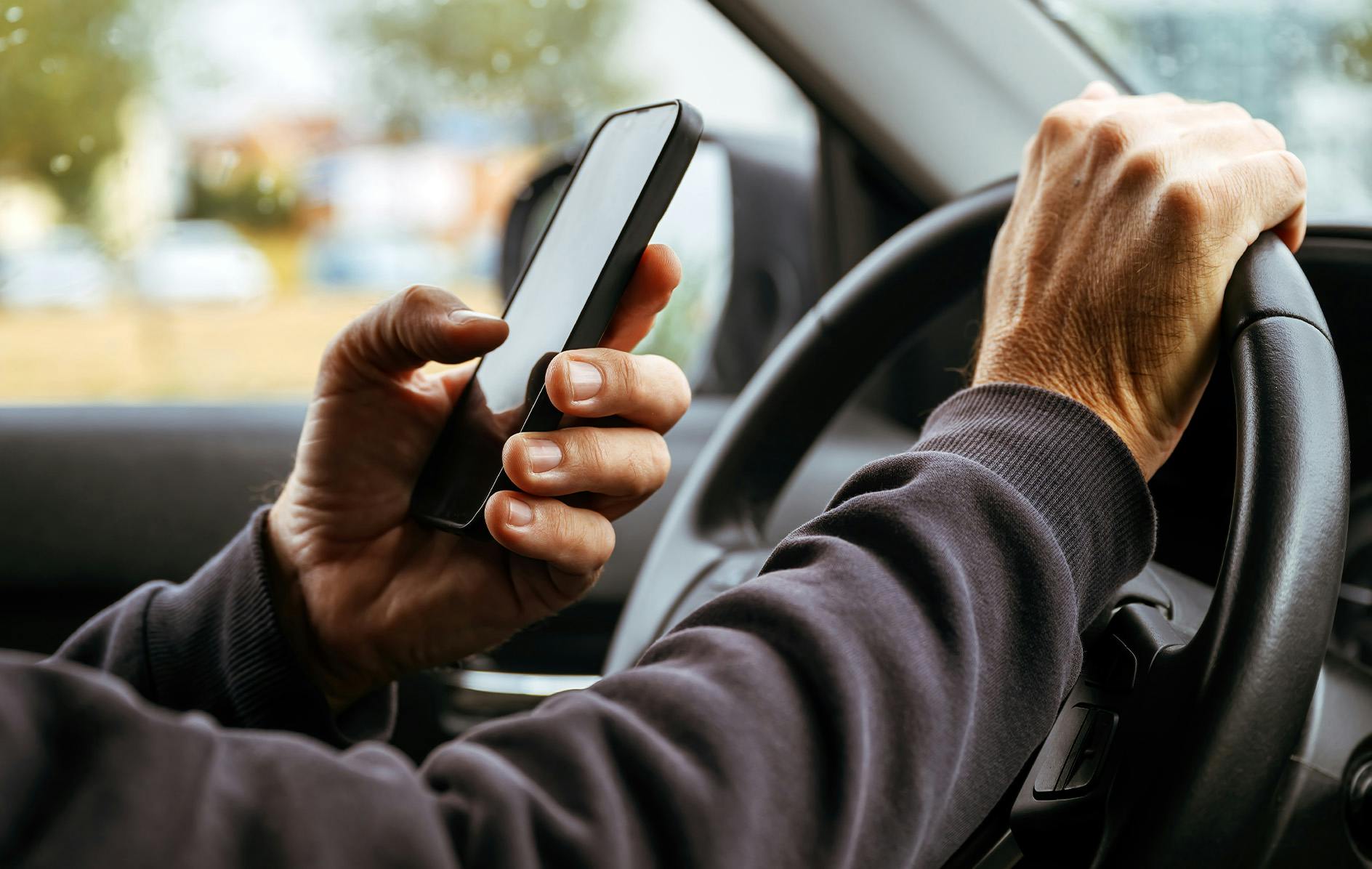 person texting while driving
