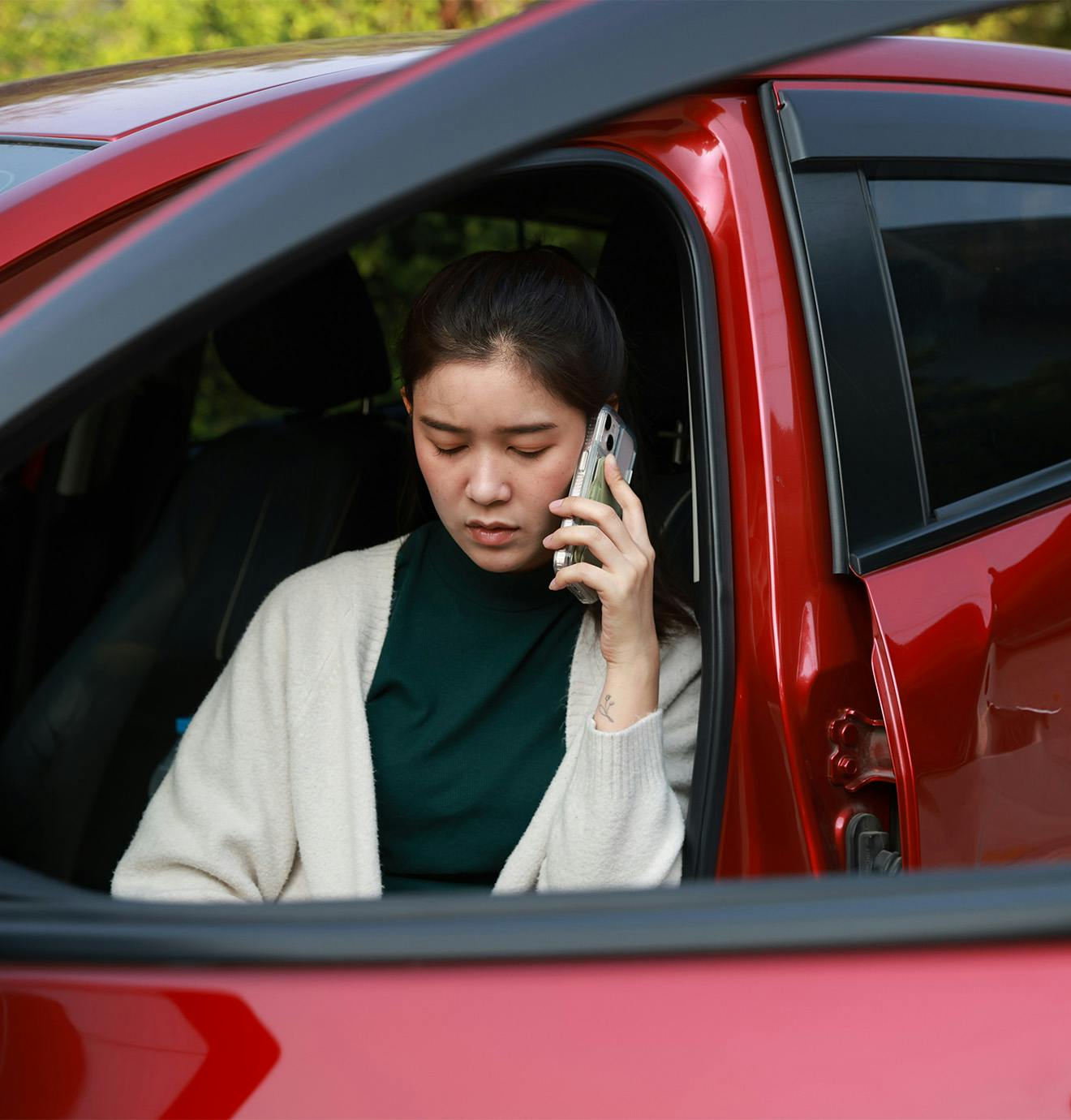 woman sitting in a car talking on the phone