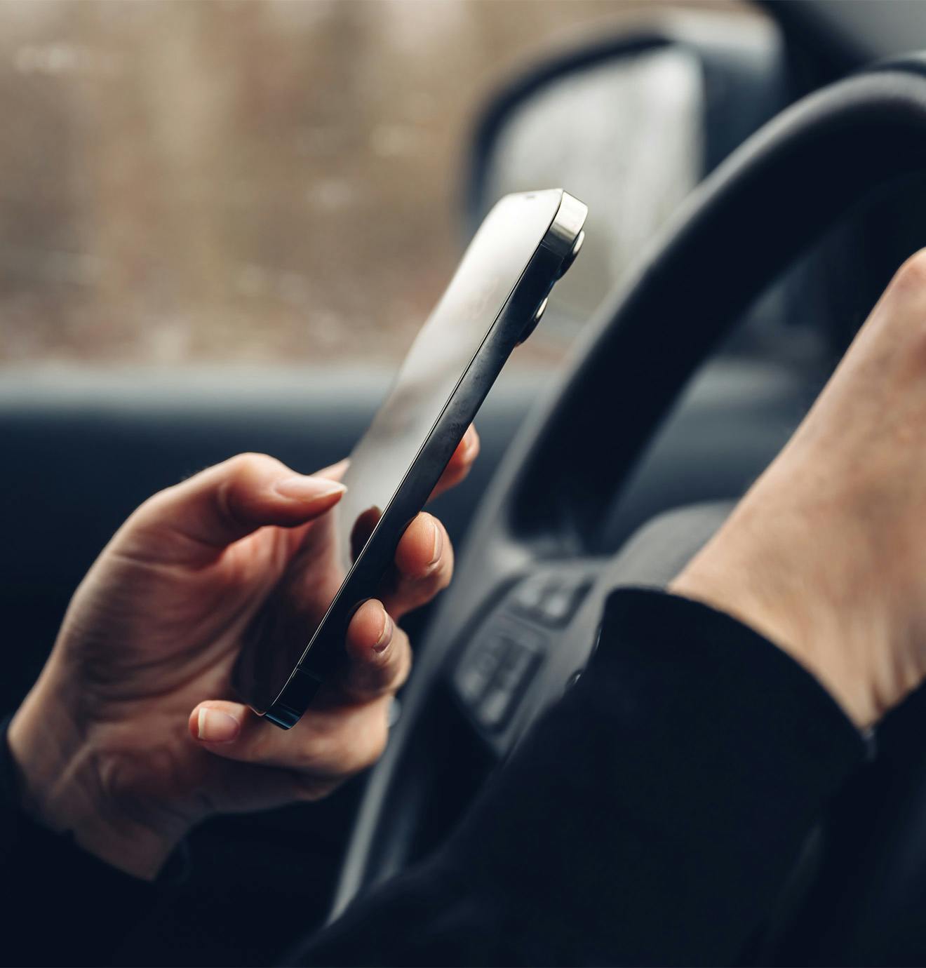 person texting while driving