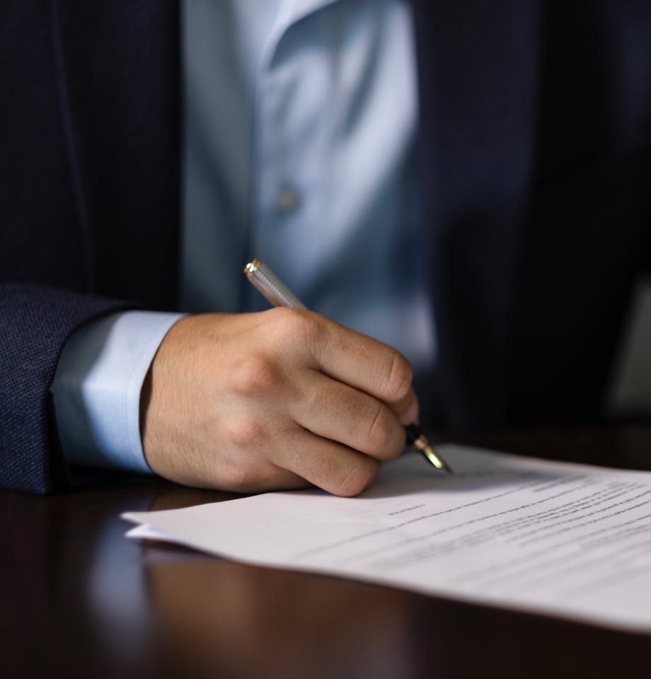 man signing a document