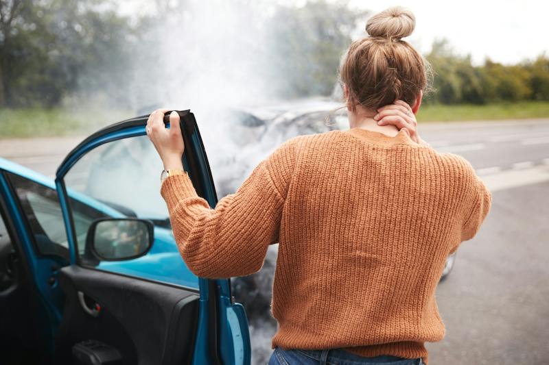 woman holding her neck after a car accident