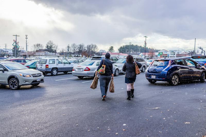 people walking in a parking lot