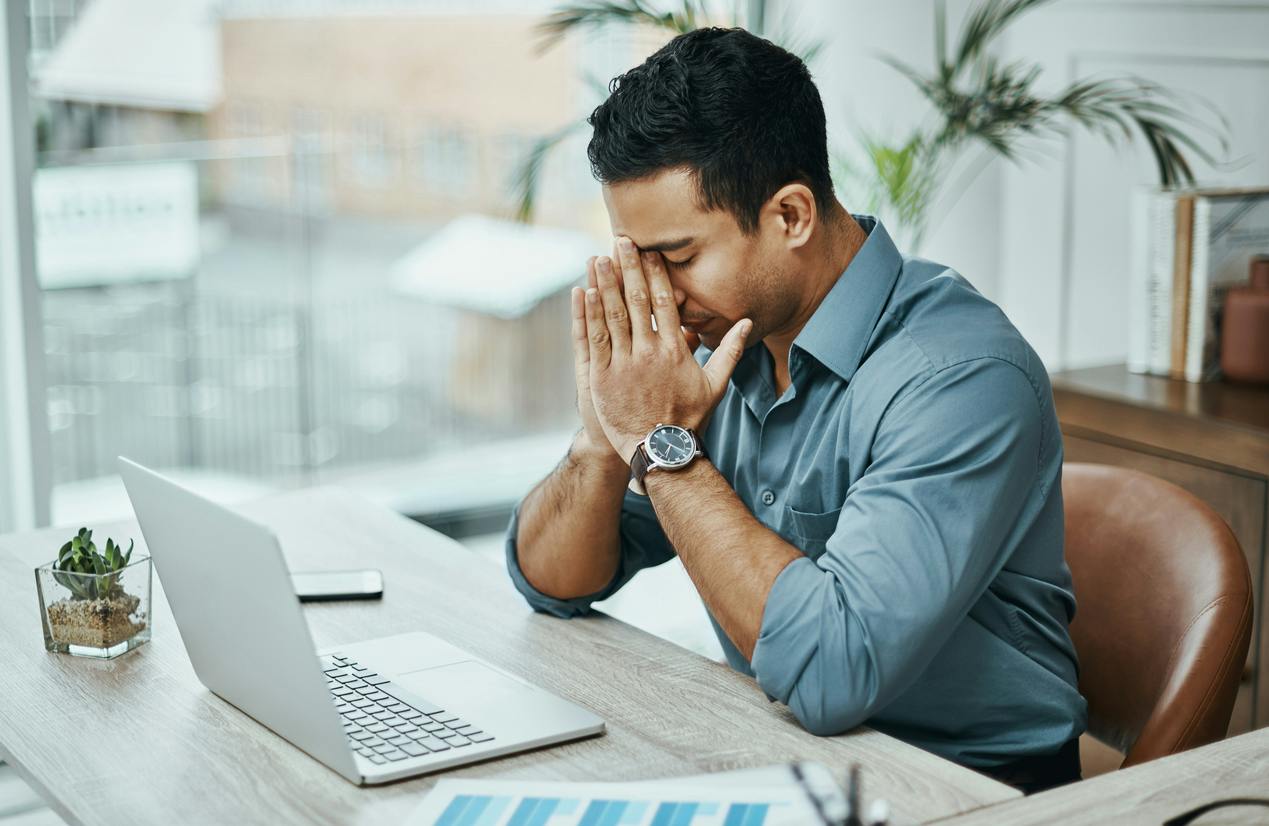 man holding his nose in frustration