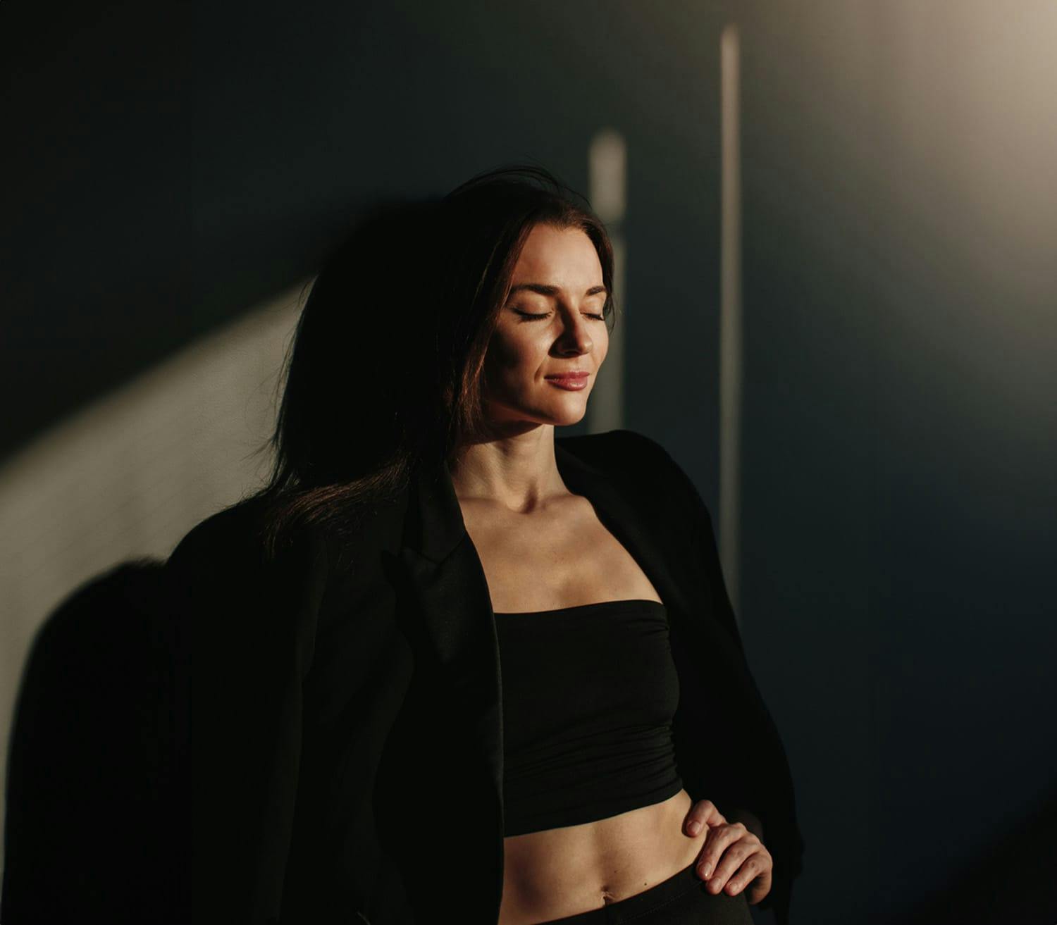 woman leaning against a wall