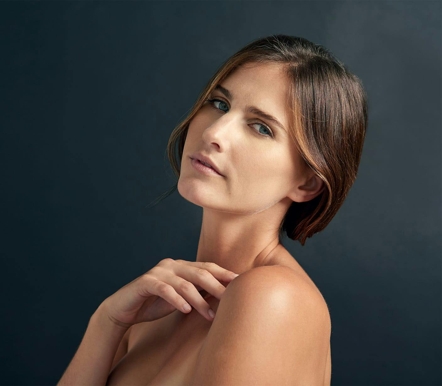 woman in tan coat standing outside