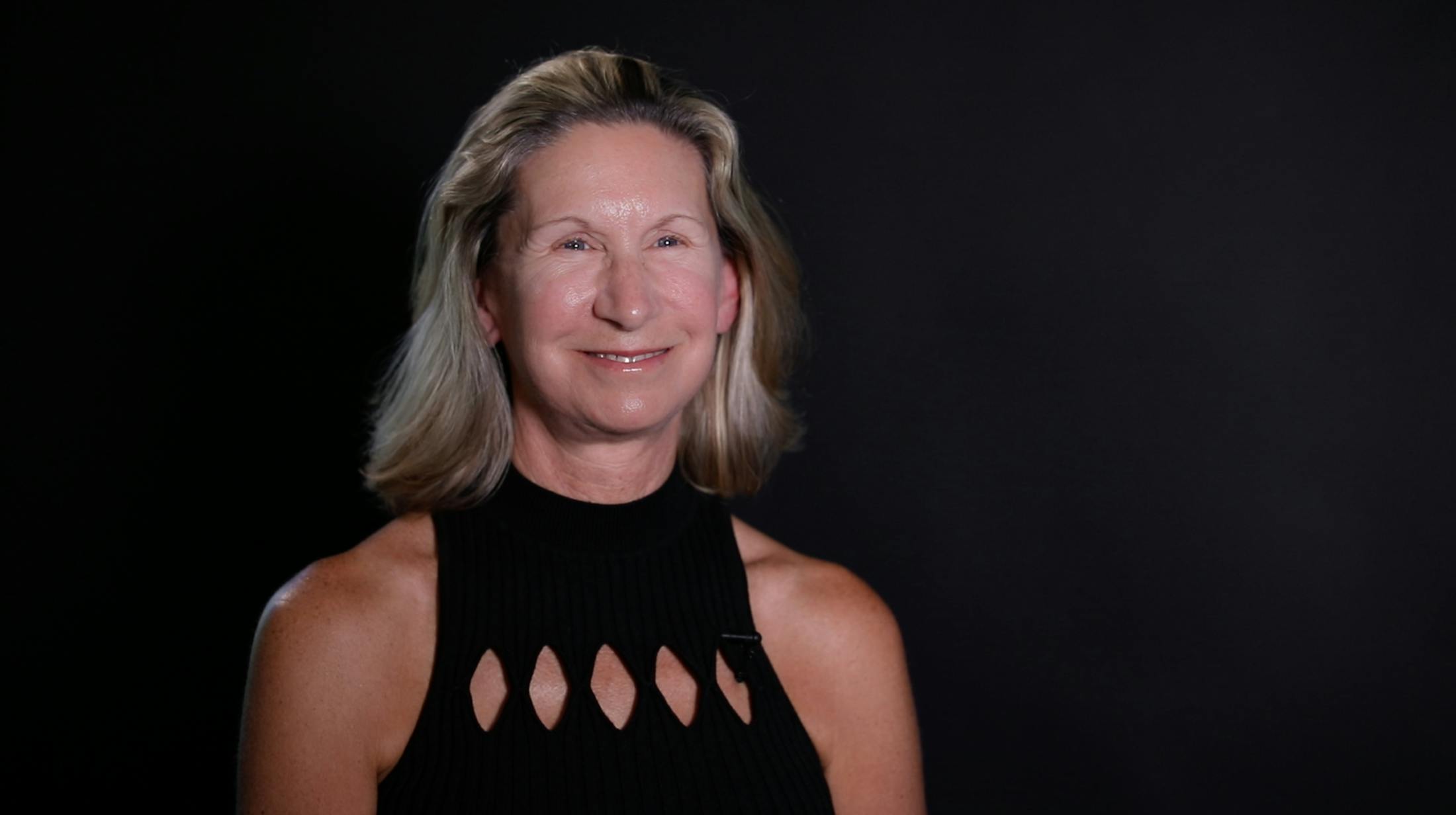 blonde woman smiling at camera