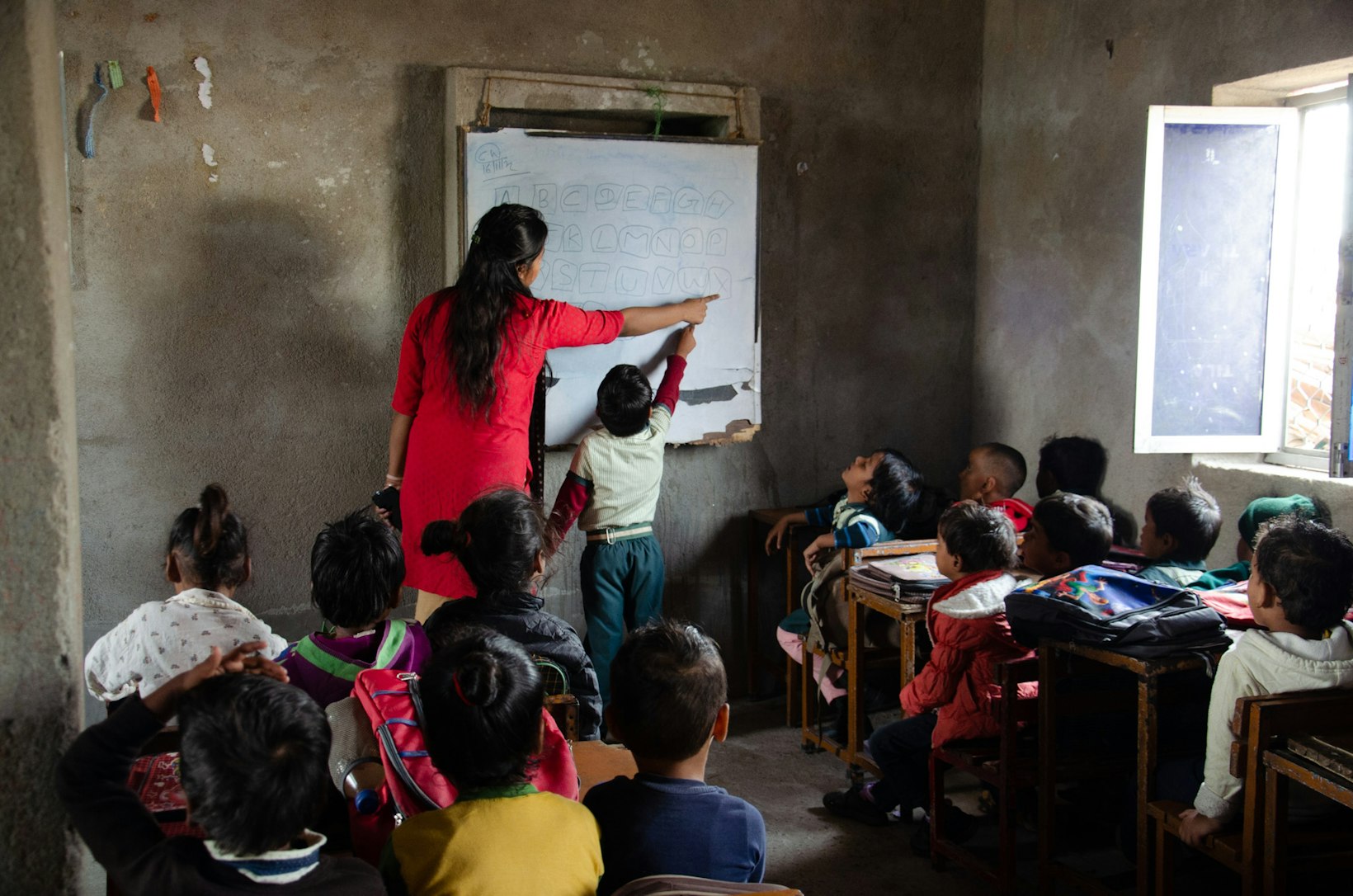 Child in classroom, India