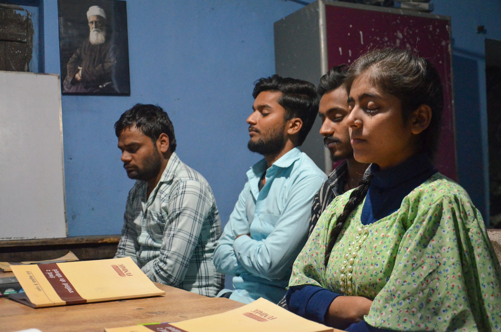 Group of youth praying together, India