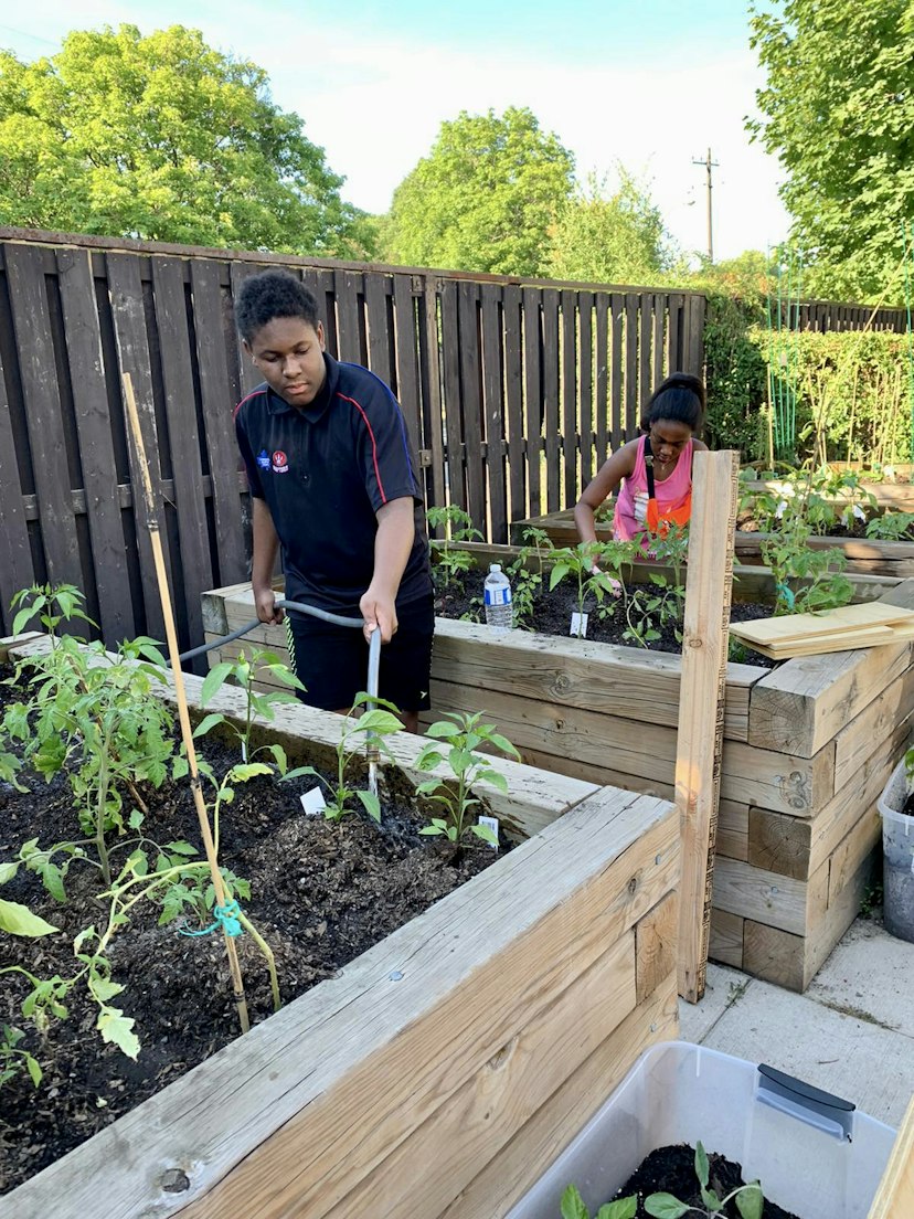 Young people tending garden, Canada