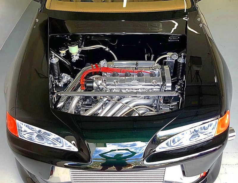 Chrome engine bay with polished valve cover and red plug wires