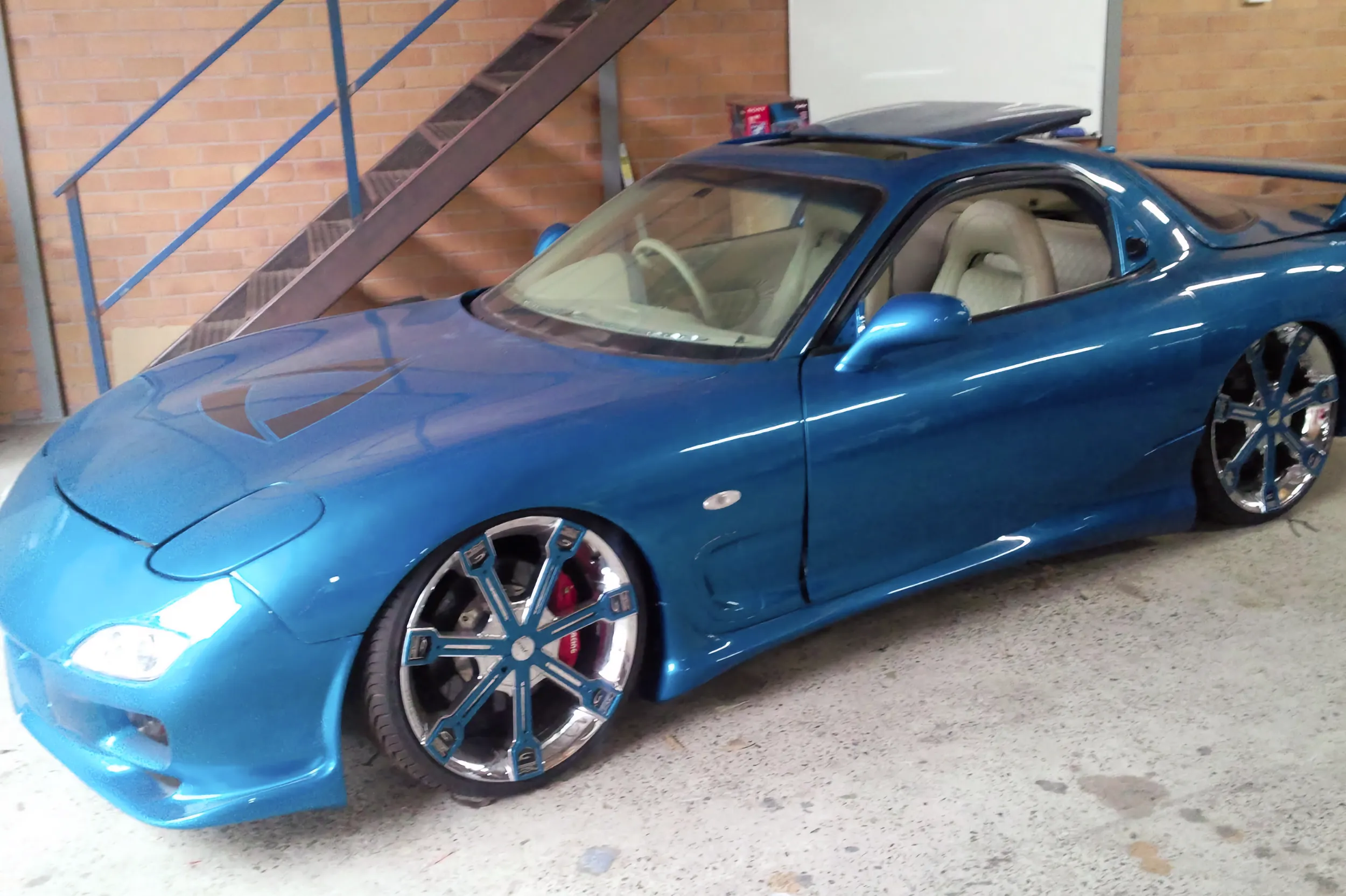 Blue FD RX7 with colour-matched wheels.